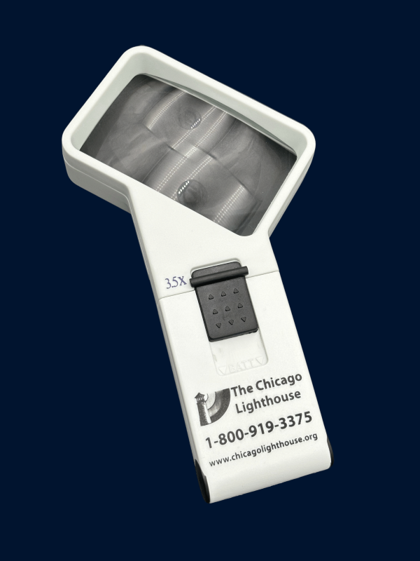 3.5X illuminated Hand-Held magnifier in white with black switch and Chicago lighthouse logo