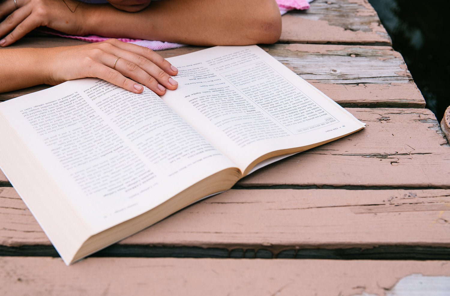 Reading a book on a picnic table