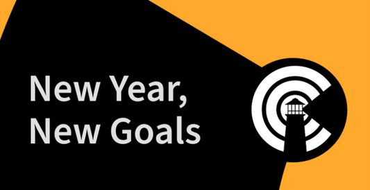 New Year, New Goals written alongside the Lighthouse Logo in high contrast white on black with orange accent color