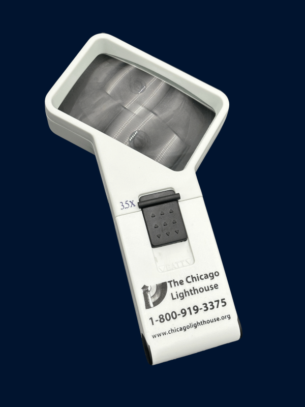 3.5X  illuminated Hand-Held magnifier in white with black switch and Chicago lighthouse logo