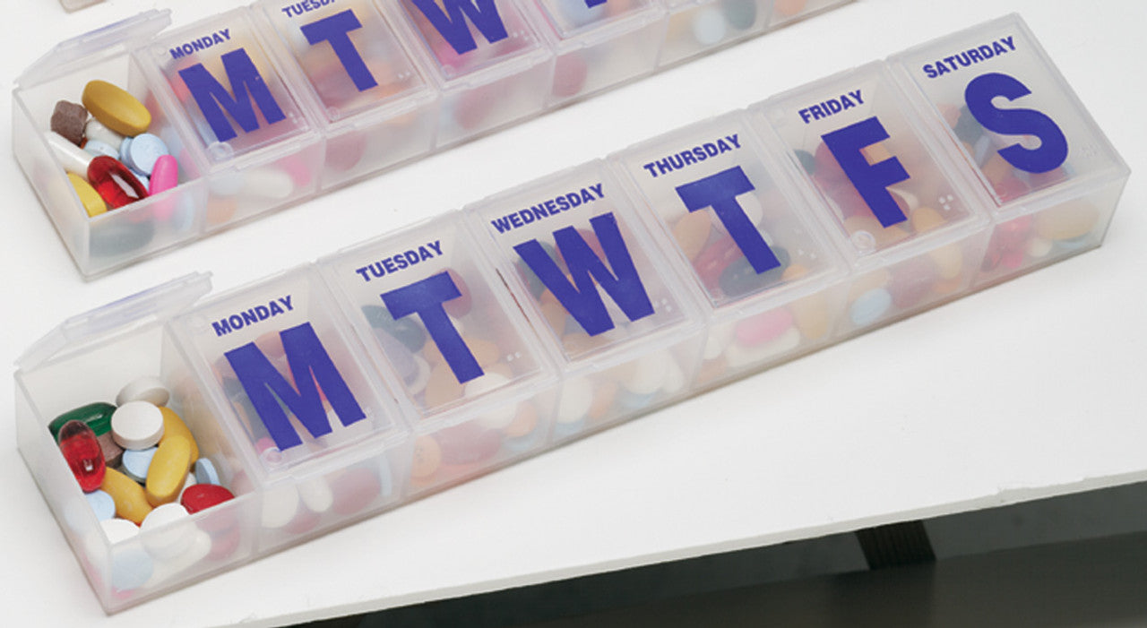 Jumbo Pill Organizer with Blue letters with braille markings on the almost clear case.