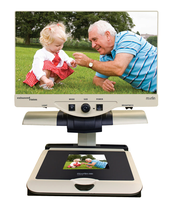 The Merlin HD Ultra featured with a photograph under the display showing a young child and an older gentleman sitting in a green field with trees in the background.