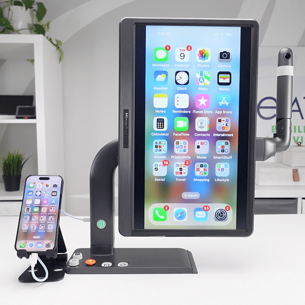 MirrorPad Pro displaying an Apple iPhone home screen mirrored onto a large touchscreen, with the phone connected for magnification.