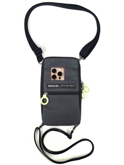 A phone holding pouch with a neck and waist strap for security. The phone has its camera poking out from a pocket in the pouch.