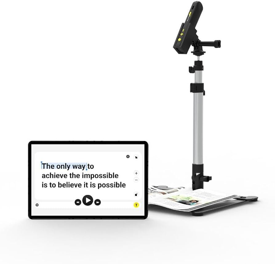 OrCam Read 3 is a revolutionary interactive AI assistant device that provides instant summarization of texts, ranging from a few sentences to an entire page of text.  Featured here is the OrCam Read being held by a silver holding stand next to a display, that shows magnification of a book that shows the text "The only way to achieve the impossible is to believe it is possible"