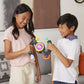 Two smiling children holding on to the arms of the Bop It Extreme Game