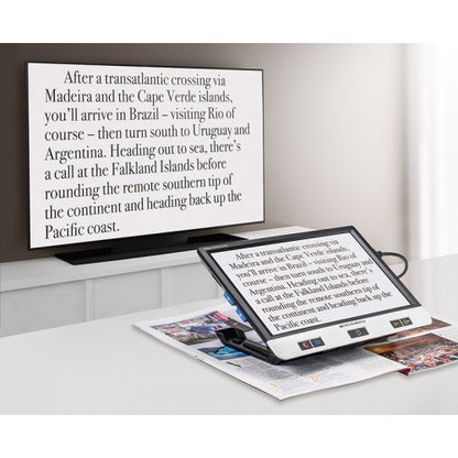 Eschenbach Visolux XL HD magnifying magazine text while also displaying the enlarged text on a television screen.