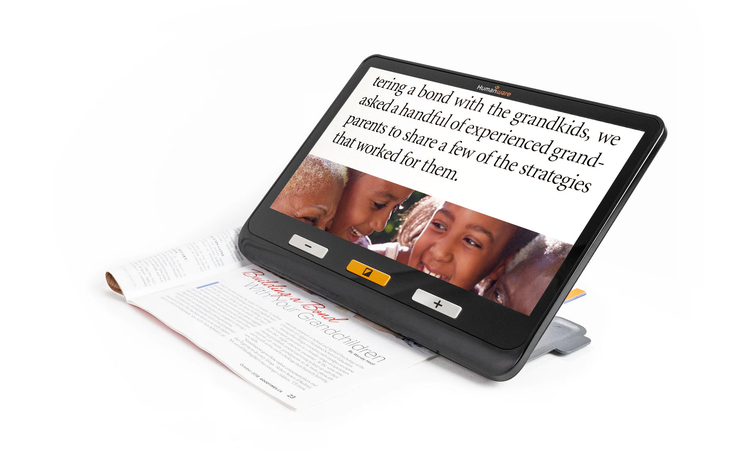 The Humanware Explore 12 product sitting atop a magazine, magnifying the text and image.