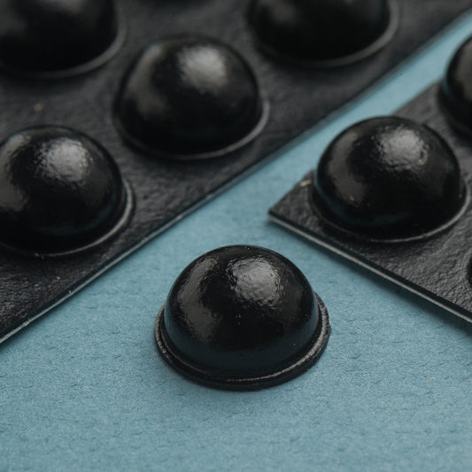 20 large round black bump-Ons. These domed shaped bump dots can be places on stoves, washing machines, remotes, and other daily living devices to assist people with low vision with locating placement on items. 