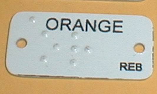 Aluminum brailled clothing marker that reads orange in both braille and text. Great stitching into your clothing if you have low vision or are blind.