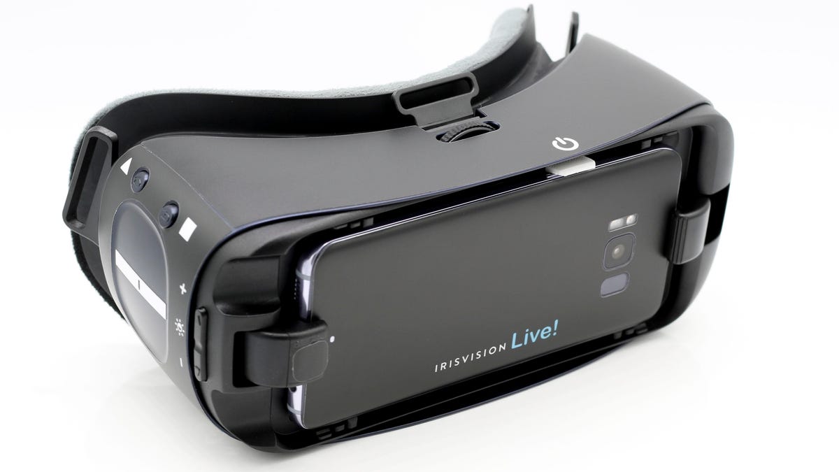 IrisVision Live electronic glasses in a black color with fully adjustable straps for hands-free use. The front of the device has a camera that delivers a 70-degree, extra-wide immersive field of view.