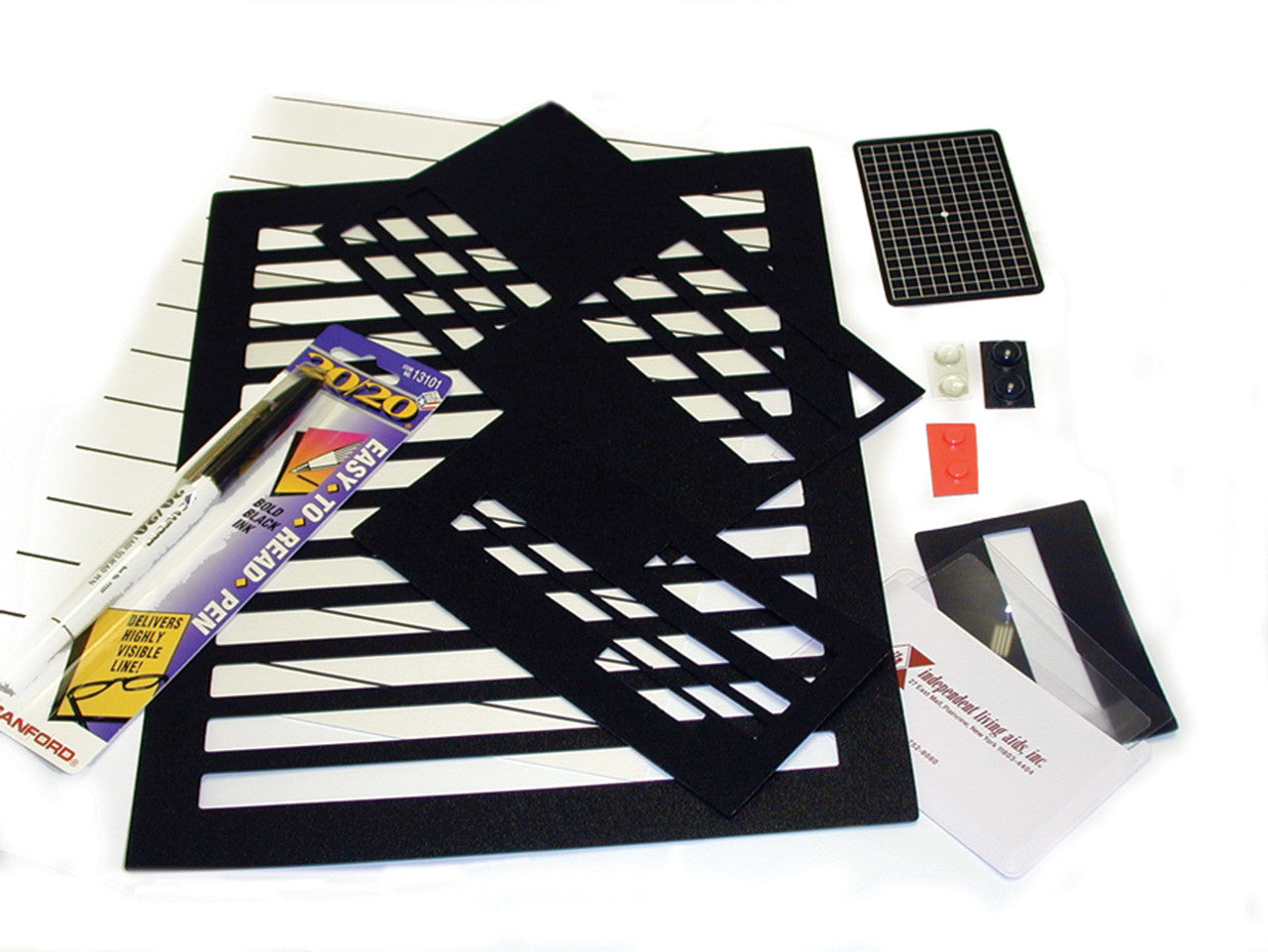 Low Vision Essentials Kit shown with an assortment of bump dots, varioussignature and letter writing guides and a sample of large lined paper, and a marker.