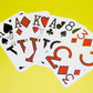 Low Vision Playing Cards By Marinoff are Designed by the ophthalmologist Dr. Gerald Marinoff to enable individuals with a vision to more easily see the numbers on these playing cards. Feature shows cards fand out in an arch revealing it's bold black and red numbers and symbols.
