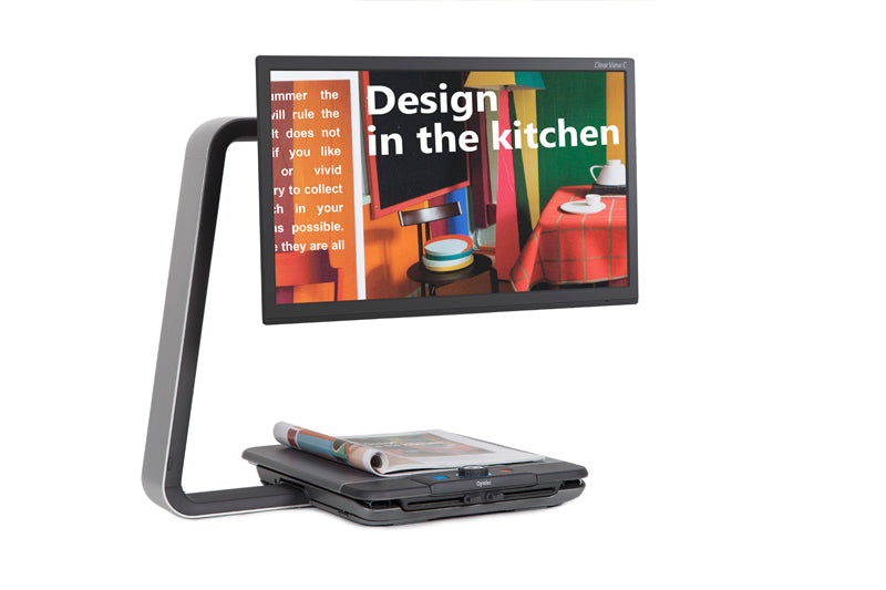 Front facing view of the Optelec ClearView C 24" HD with a colorful magazine enlarged on it's 24" screen.