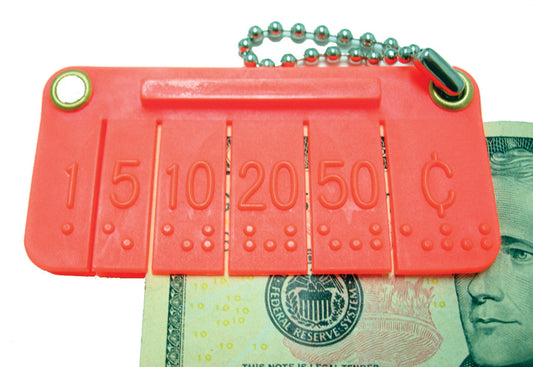 Orange Pocket Money Brailler ona linked keychain with a dollar inside of the brailing device.